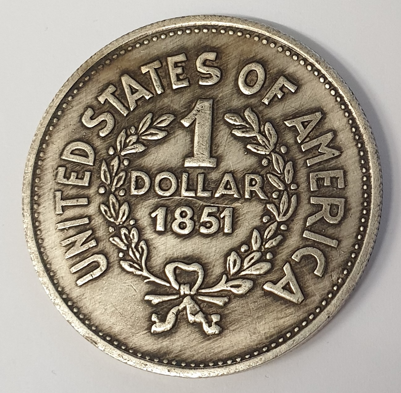 UNITED STATES OF AMERICA 1851 . ONE DOLLAR . INDIAN HEAD TOKEN
